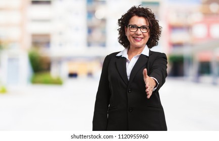 Full Body Middle Age Business Woman Reaching Out To Greet Someone Or Gesturing To Help, Happy And Excited