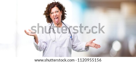 Full body middle age doctor woman expression of confidence and emotion, fun and friendly, showing tongue as a sign of play or fun