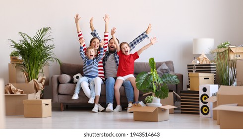 Full Body Optimistic Parents And Kids Raising Arms And Screaming In Excitement While Sitting On Couch In New Flat