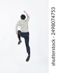 Full body photo of an Asian male student jumping in front of a white background rear view