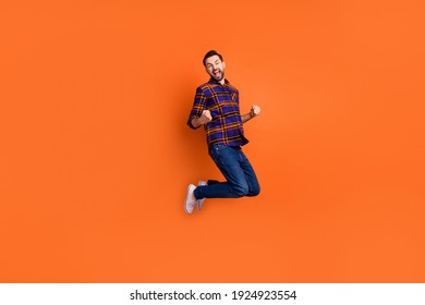 Full body photo of astonished person fists up open mouth shout yes isolated on orange color background - Shutterstock ID 1924923554