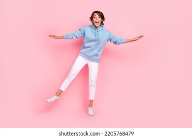 Full body photo of astonished pretty lady stand one foot balance good mood empty space isolated on pink color background - Powered by Shutterstock