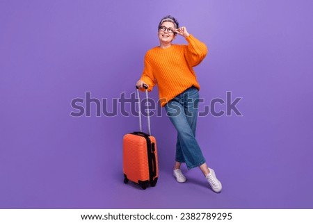 Full body photo of attractive grey hair businesswoman touch glasses holding suitcase dreamy look mockup isolated on purple color background