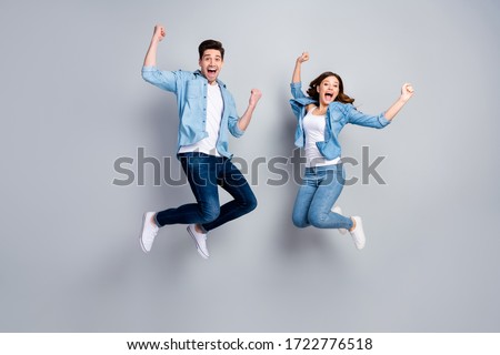 Full body photo of attractive lady handsome funny guy crazy fan jumping high up celebrating football team winning wear casual denim shirts outfit isolated grey color background