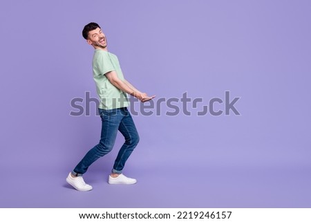 Full body photo of attractive man carry empty space invisible heavy box dressed stylish gray garment isolated on purple color background ストックフォト © 
