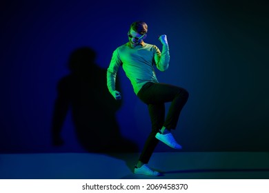 Full body photo of attractive young positive man good mood winner wear sunglass isolated on neon background