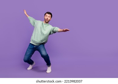 Full body photo of attractive young guy surfing falling keep balance wear trendy gray garment isolated on violet color background - Powered by Shutterstock