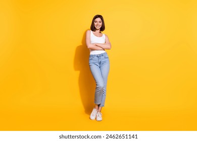 Full body photo of attractive young girl crossed hands confident wear trendy white outfit isolated on yellow color background - Powered by Shutterstock