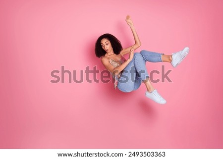 Full body photo of attractive young woman falling down nervous dressed stylish sequins clothes isolated on pink color background