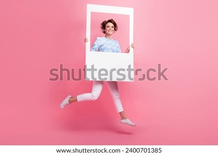 Full body photo of carefree pretty lady jump hands hold paper album card window isolated on pink color background