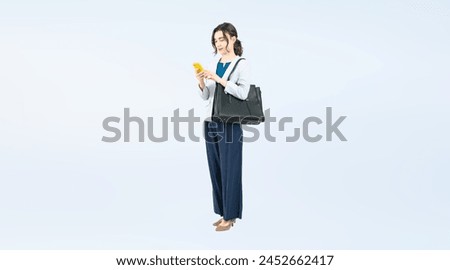 Full body photo of a Caucasian female businessperson using a smartphone