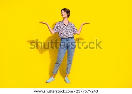 Full body photo of charming creative lady look arms hold empty space vs scales isolated on yellow color background