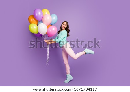 Full body photo of cheerful feminine girl hold many baloons enjoy festive woman day event scream wear turquoise pastel sweater pink footwear isolated over purple color background