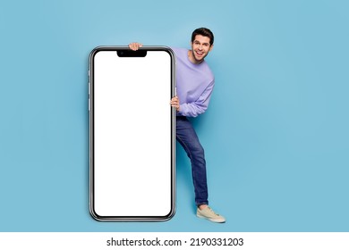 Full body photo of cheerful funny guy demonstrate empty space blank offer isolated on blue color background