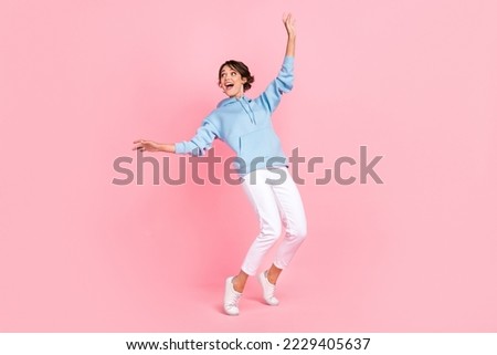 Full body photo of cheerful lady dressed stylish blue clothes stand toes interested look empty space isolated on pink color background