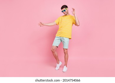 Full body photo of cheerful young happy man dance wear sunglass vacation summer isolated on pink color background