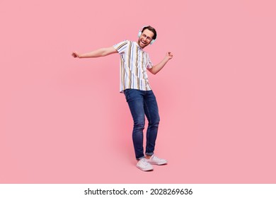 Full Body Photo Of Cheerful Young Funky Young Man Dance Good Mood Wear Headphones Isolated On Pink Color Background