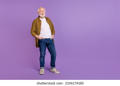 Full body photo of cheery granddad grey hair hands pockets dressed trendy yellow checkered shirt isolated on lilac purple color background - Powered by Shutterstock