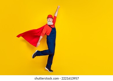 Full body photo of confident manufacturing pensioner technician raise fist up isolated on bright color background - Powered by Shutterstock