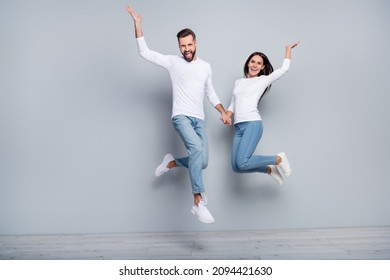 Full Body Photo Of Cool Millennial Brunet Couple Jump Wear White Shirt Jeans Shoes Isolated On Grey Background