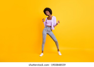 Full body photo of cool positive dark skin lady look empty space toothy smile isolated on yellow color background