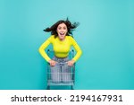 Full body photo of crazy brunette hair millennial lady in trolley wear shirt jeans isolated on teal color background