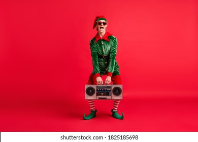 Full Body Photo Of Crazy Elf Hold Boom Box On X-mas Christmas Party Wear Costume Isolated Over Bright Color Background