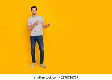 Full Body Photo Of Cute Brunet Young Guy Index Promo Wear T-shirt Jeans Shoes Isolated On Yellow Background