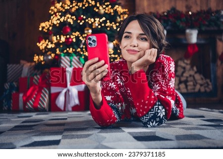 Full body photo of cute lady video call friends waiting santa claus hold iphone send wishlist shopping isolated xmas tree background