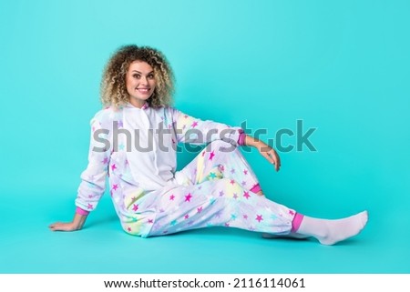 Full body photo of cute millennial wavy hairdo lady sit wear overall socks isolated on blue background