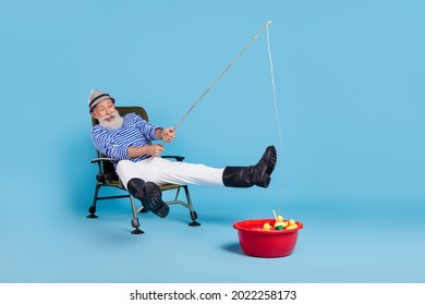 Full body photo of excited happy cheerful old man sport fisherman weekend isolated on blue color background