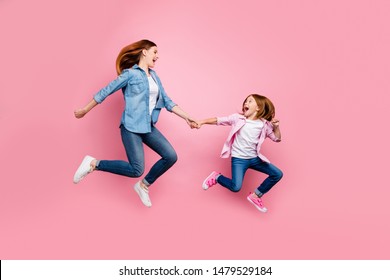 Full Body Photo Of Foxy Little Lady And Her Excited Mom Jumping High Wear Casual Jeans Outfit Isolated Pink Background