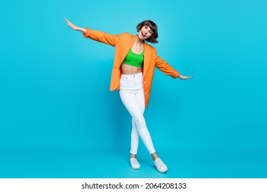 Full body photo of funky young brunette lady dance wear blazer top jeans shoes isolated on teal color background