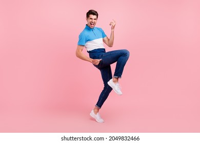 Full Body Photo Of Funny Brunet Millennial Guy Stand Wear Polo Jeans Sneakers Isolated On Pink Background