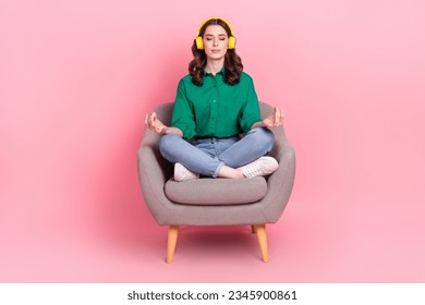 Full body photo of gorgeous calm lady sit comfort chair listen music meditate isolated on pink color background