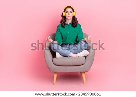 Full body photo of gorgeous calm lady sit comfort chair listen music meditate isolated on pink color background