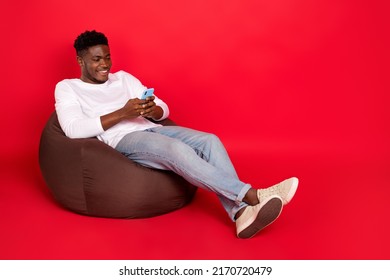 Full Body Photo Of Guy Blogger Sit Bean Chair Use Device Like Post Comment Isolated Bright Color Background