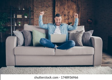 Full Body Photo Of Handsome Homey Guy Relaxing Sitting Comfy Couch Legs Crossed Browsing Notebook Freelancer Remote Work Stay Home Quarantine Got Big Salary Living Room Indoors