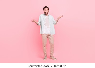 Full body photo of handsome young guy irritated scolding argument hands dressed stylish blue clothes isolated on pink color background