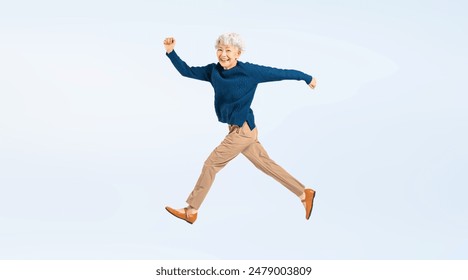 Full body photo of a jumping senior woman - Powered by Shutterstock