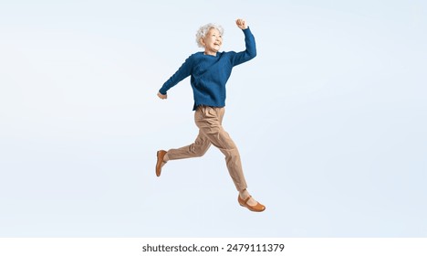 Full body photo of a jumping senior woman - Powered by Shutterstock