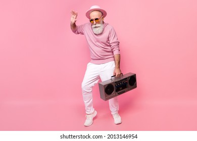 Full Body Photo Of Nice Funky Grey Hair Elder Man Dance With Boom Box Wear Eyewear Cap Sweater Isolated On Pink Background