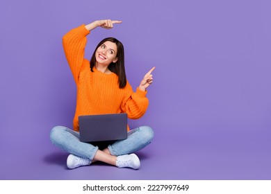 Full body photo of nice young girl netbook look direct empty space wear trendy orange knitwear garment isolated on violet color background - Shutterstock ID 2227997649