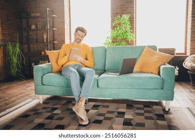 Full body photo of nice young man sit couch online study write notebook wear yellow clothes modern interior flat indoors