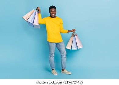 Full Body Photo Of Optimistic Millennial Brunet Guy Hold Bags Wear Smart Casual Isolated On Blue Background