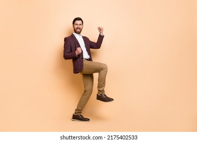 Full Body Photo Of Overjoyed Ecstatic Male Celebrate Personal Achievement Isolated On Beige Color Background