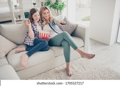 Full Body Photo Of Pretty Lady Mom Daughter Sit Sofa Hugging Eat Popcorn Switch On Tv Set Watch Favorite Comedy Stay Home Quarantine Spend Time Together Best Friends Living Room Indoors