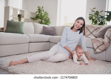 Full body photo of pretty positive girl adorable toddler sitting carpet floor rest relax spend free time indoors - Powered by Shutterstock