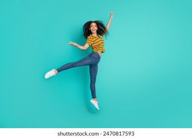 Full body photo of pretty young girl jump dance ballet wear trendy striped outfit isolated on aquamarine color background - Powered by Shutterstock