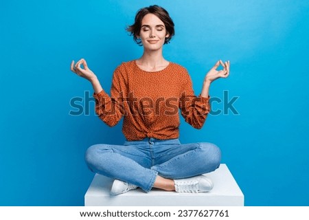 Full body photo of pretty young girl sit white platform meditation pose wear trendy brown outfit isolated on blue color background